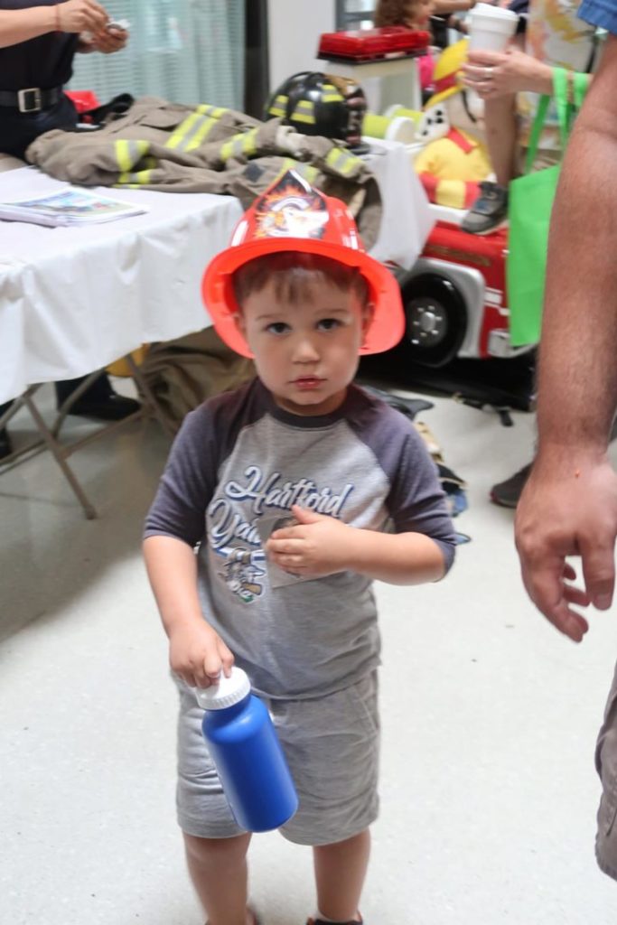 Kid in fireman helmet at Kids Safety Expo