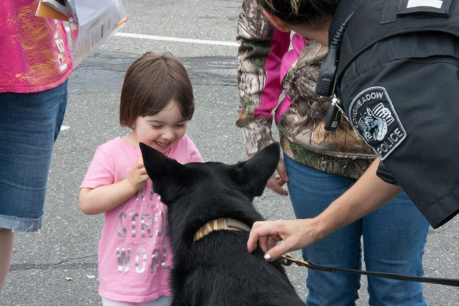 Little girl and police dog at Kids Safety Expo 2018